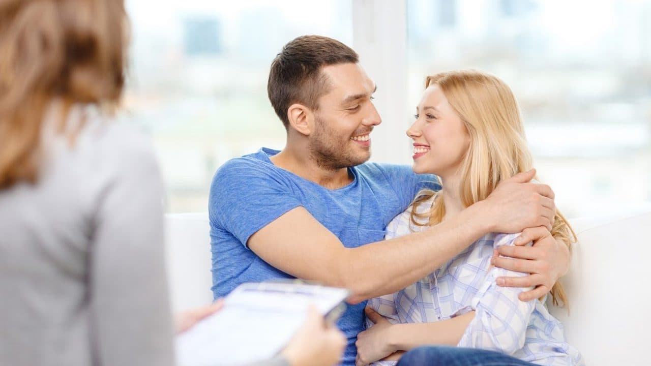 An engaged couple talking during a premarital counseling session