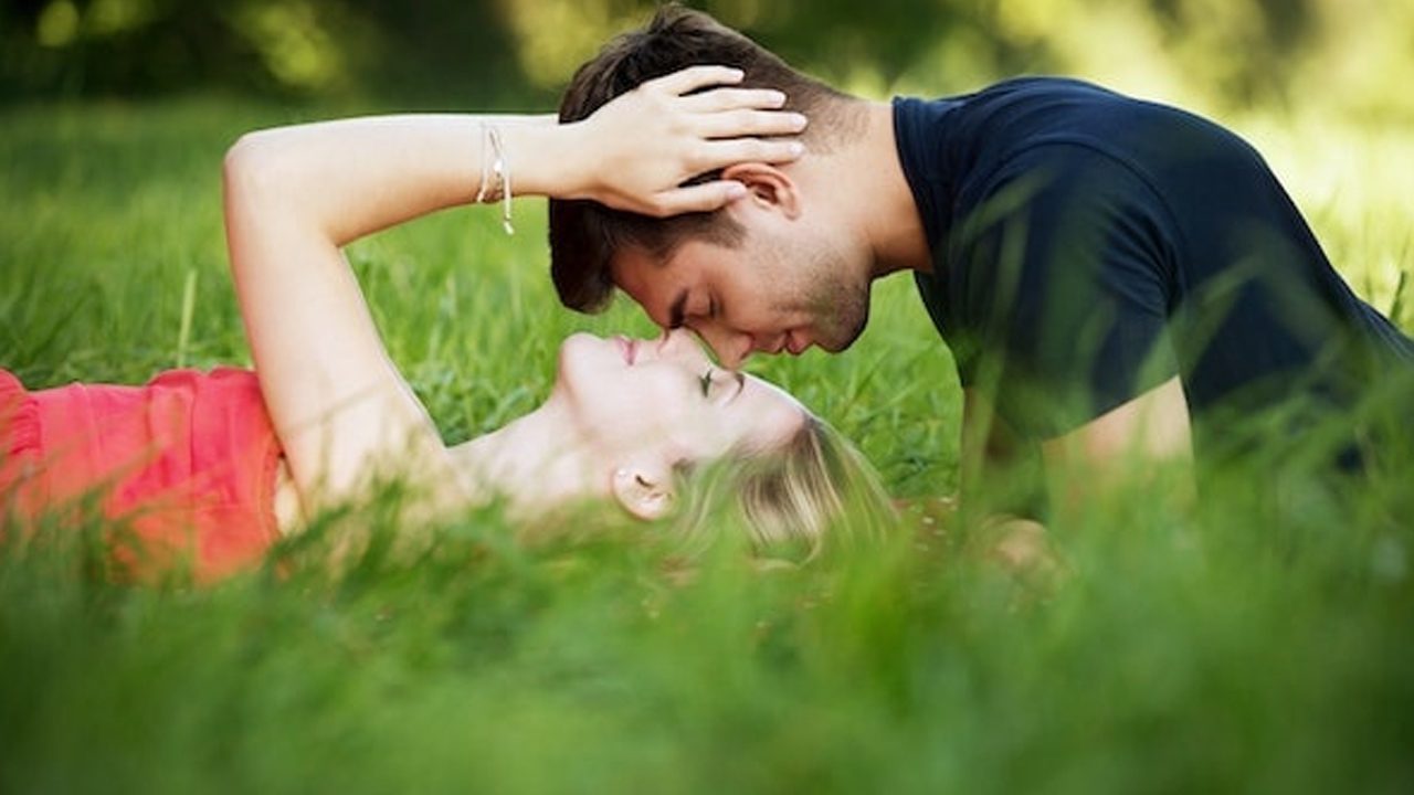 Couple embracing outside in the grass