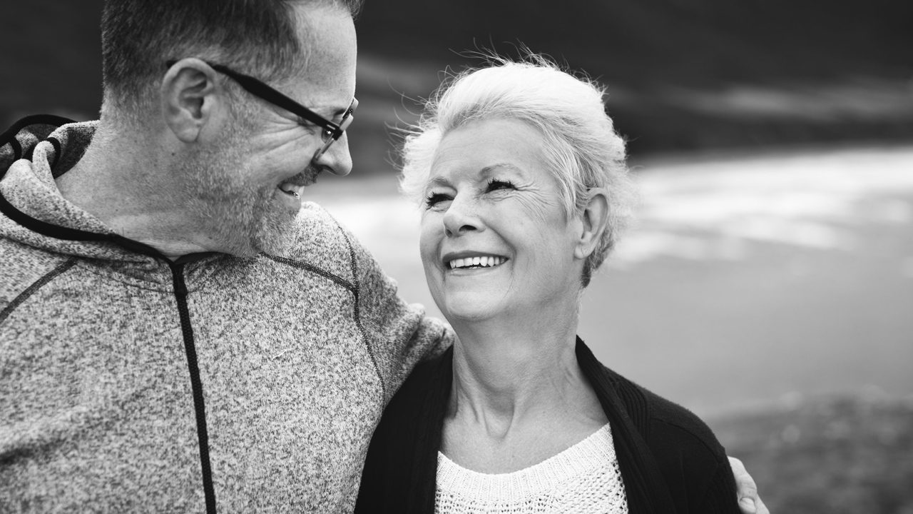 Happily married elderly couple walking outside