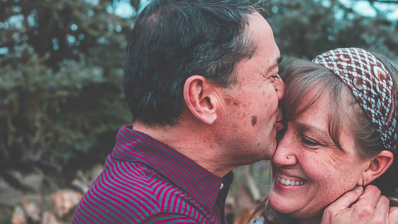 Married couple kissing