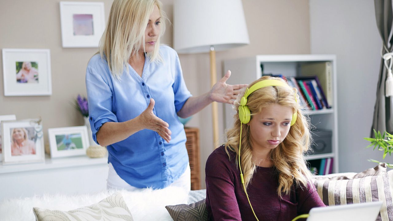 Mother talking to daughter while she ignores her