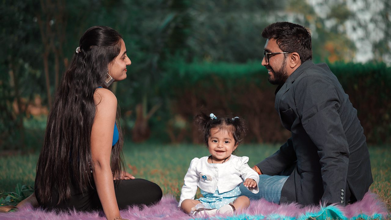 Married couple with small child at a picnic